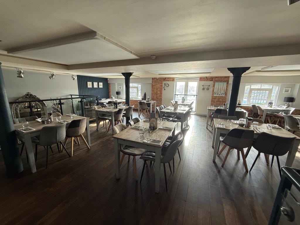 Lot: 70 - RESTAURANT IN MARINA LOCATION WITH POTENTIAL - First Floor seating area looking toward the marina